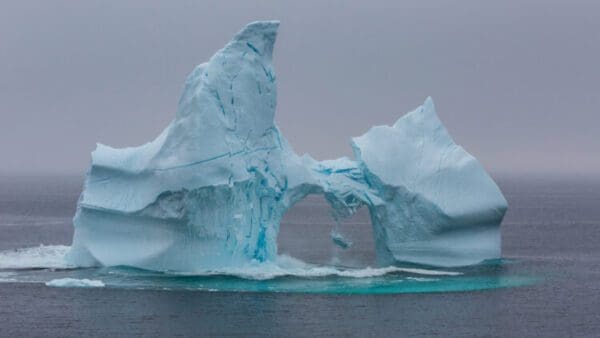 A large iceberg with a hole in it